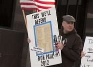 Ron Paul supporters gather outside a building in downtown Austin on Feb. 24, 2012, expecting to see GOP presidential hopeful Rick Santorum, who was in town for a fundraiser.