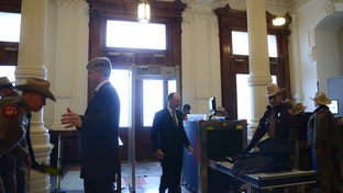 Capitol visitors pass through metal detectors.