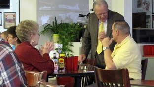 Rep. Delwin Jones (standing) talks to voters in a Lubbock diner.