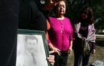 Juanita Guerra, second from right, stands at the grave of her husband in the San Benito Mont Meta Cemetery with her daughters on Sunday Dec. 12, 2010. Ms. Guerra is suing Service Corporation International, the largest funeral services provider in North America, for moving her husband's remains without her permission.