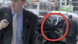 Screengrab of Perry's staffer heading to block a KBH videographer from the sidewalk.