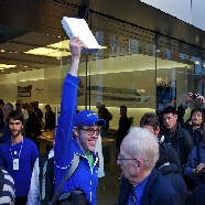 Excited customer holds up his new ipad