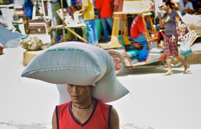 man with bag of rice on head