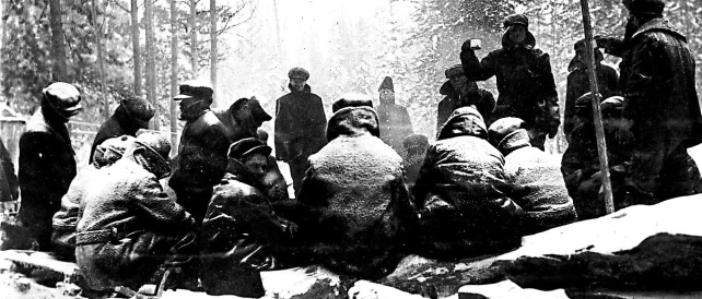 Internees huddled around fire