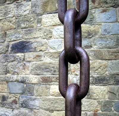 Chain in front of brick wall