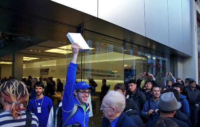 Excited customer holds up his new ipad
