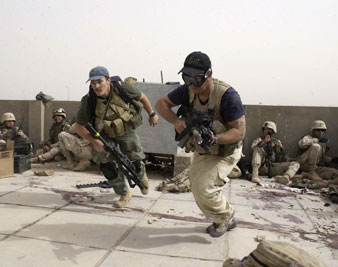 Plainclothes contractors working for Blackwater USA take part in a firefight, April 2004. AP Images</br>