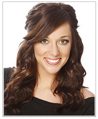 Model with a deep side part and half up hair