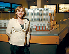 Toby Klein of Muss Development in front of a model of Sky View Parc, a massive mixed-use development in Flushing.