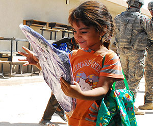 An Iraqi child carries school supplies and a new backpack donated by Iraqi Security Forces during an ISF-led combined medical and humanitarian engagement in Karmah, Iraq, Sept. 7, 2010. U.S. Army photo by Staff Sgt. Tanya Thomas.