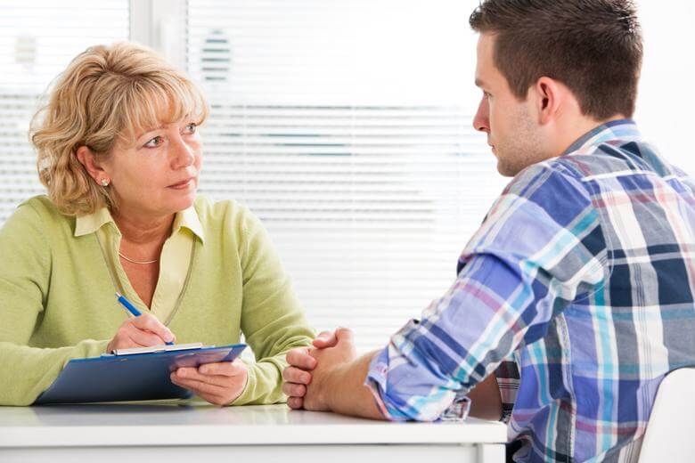 A rehabilitation counselor leads a client consultation.