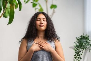 A counselor practices breathing exercises.