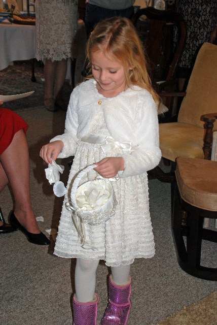 The flower girl, Olivia Stone, granddaughter of the bride, dropped her rose petals from the dining room to the living room, site of the ceremony.
