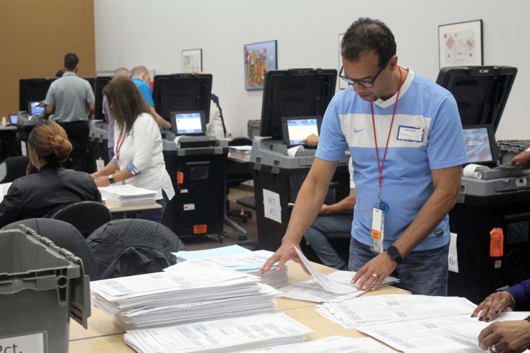 Timothy Frazier sorts through ballots at the Orange County Supervisor of Elections. Recounting started November 12, 2018 in Orange County. Photo by Shanya Richburg.