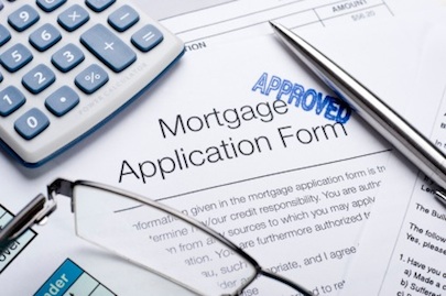 Approved Mortgage application form with a calculator and pen FHA Mortgage
