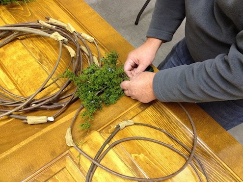 Starting the wreath with a piece of fresh cedar How to Make a Wreath - Starting the Process