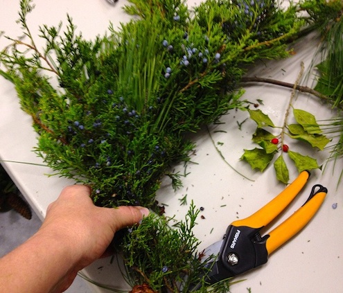 Continuing to fill the form with greenery How to Make a Wreath - Adding Greenery