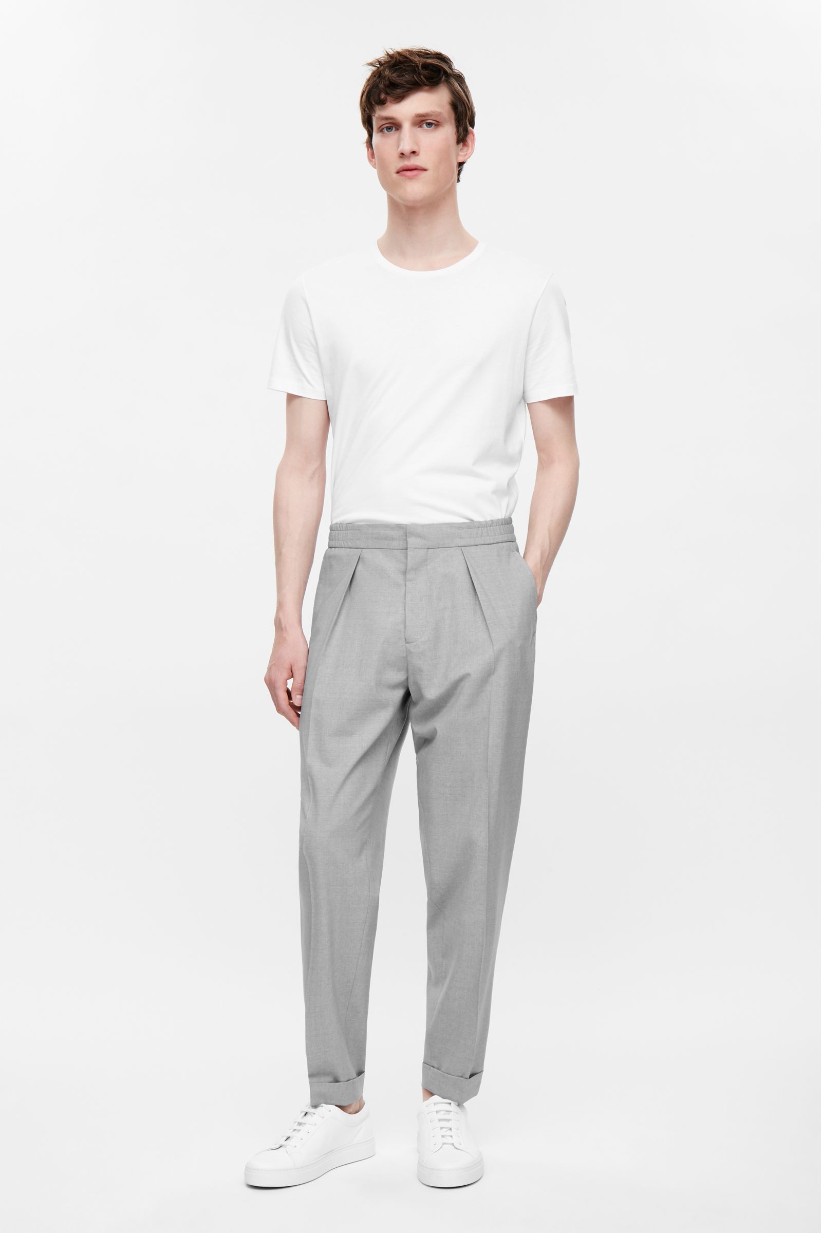 Man wearing pleated trousers