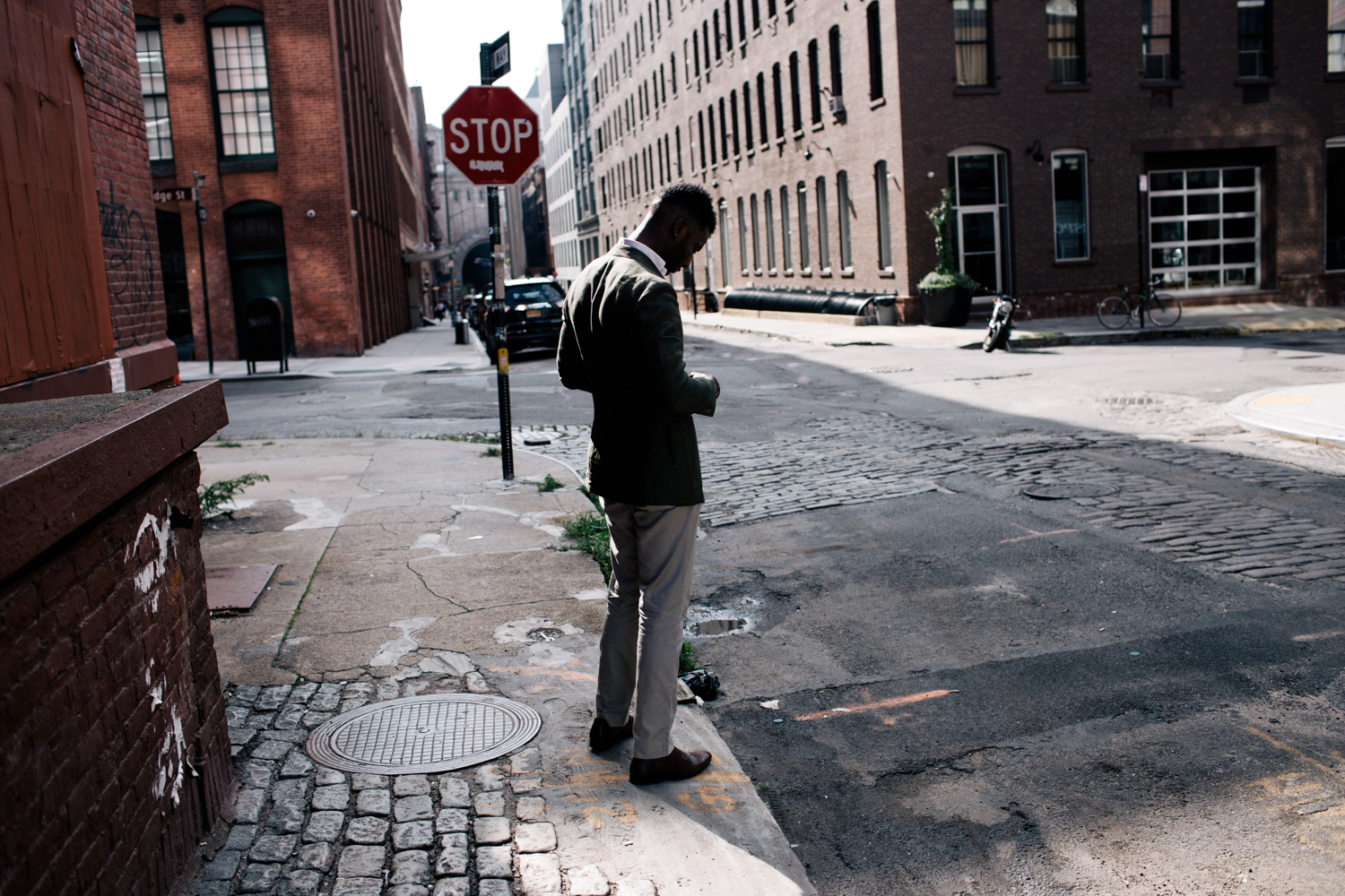 Wayne Wilson in a green jacket in the streets of Dumbo