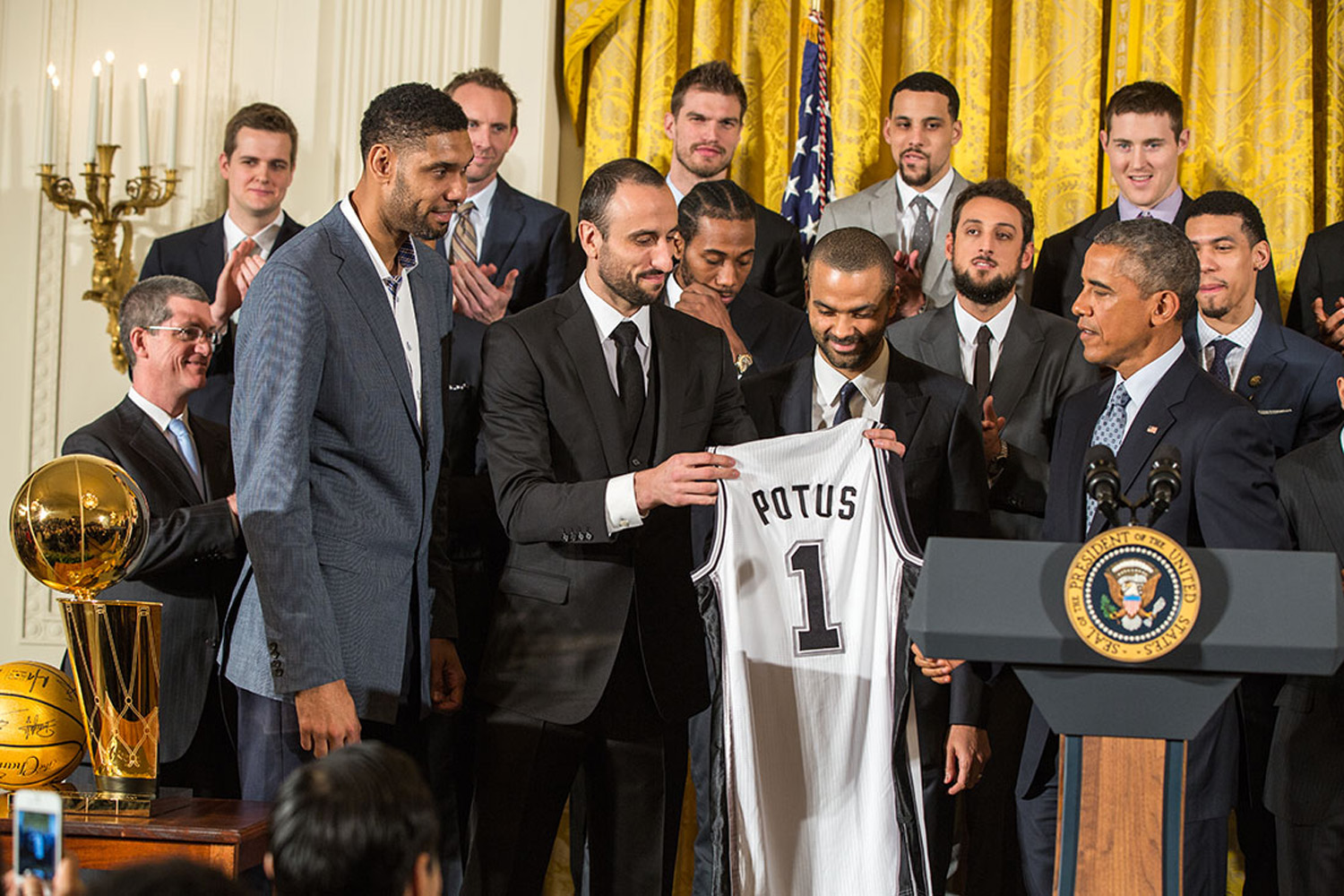 Tim Duncan, Manu Ginóbili and Tony Parker present President Barack Obama with a Spurs team jersey during an event to welcome the 2014 NBA Champion San Antonio Spurs in the East Room of the White House, Jan. 12, 2015. (Official White House Photo by Pete Souza)