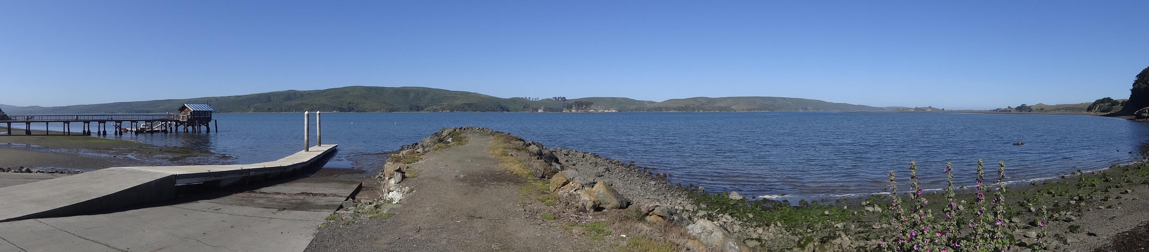 (Wide) Tomales Bay is an odd place. It is so straight, narrow and shallow. It is the San Andreas fault dropping a little underwater before it heads into the ocean at Bodega Bay. Each side of the bay is on a different tectonic plate. This side is heading slowly south. Point Reyes, like Bodega Head is going north. For the next 30 miles, the road follows the fault.