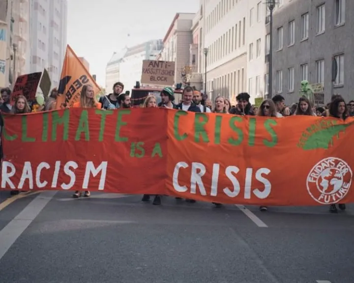 March for climate strikes with a banner that reads Climate Crisis is a Racism Crisis