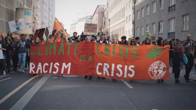 March for climate strikes with a banner that reads Climate Crisis is a Racism Crisis