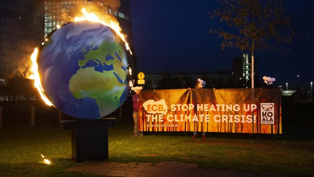 A model planet Earth was set on fire in front of the ECB headquarters in Frankfurt.