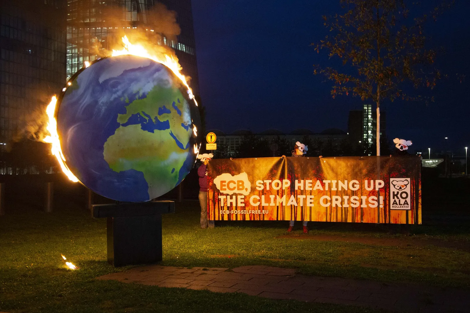 A model planet Earth was set on fire in front of the ECB headquarters in Frankfurt.
