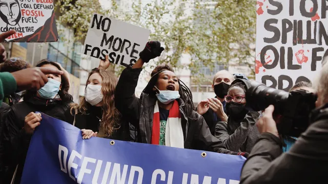 Young people protesting against fossil finance outside Standard Chartered Bank.