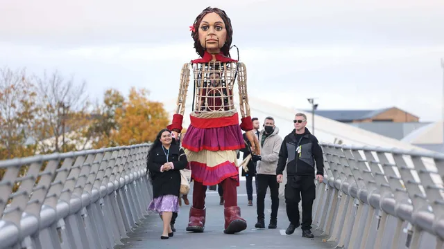 Little Amal and Pacific Climate Warrior Brianna Fruean approach COP26 in Glasgow.