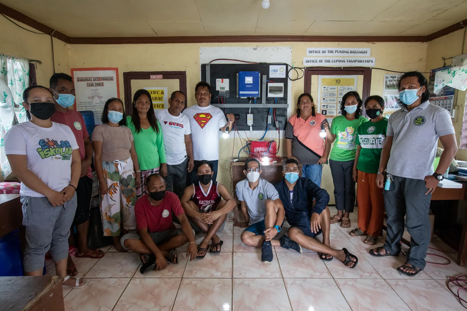 ICSC staff, RE-serve volunteers, Limasawa DRRMO, and Barangay officials of San Agustin pose in front of the PV system turned over by ICSC and 350 Pacific. Photo: Kathleen Lei Limayo/ 350.org