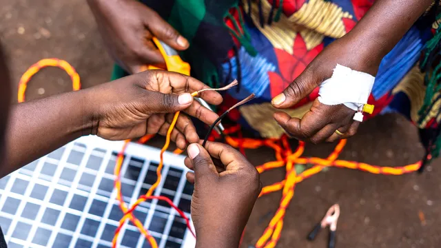 Close-up on women stripping electric wires