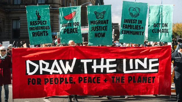 Activists gathered on Parliament Hill in Ottawa, Canada for a large Draw The Line rally and public mural painting.
