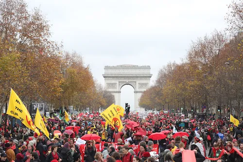 On the last day of the Paris summit, activists draw "climate red lines" in front of the Arc de Triomph