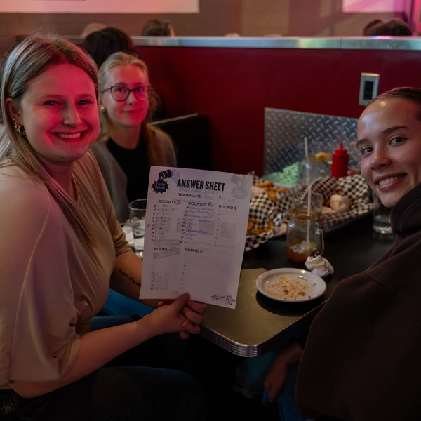 Toxic Trivia Participants Holding Answer Sheet