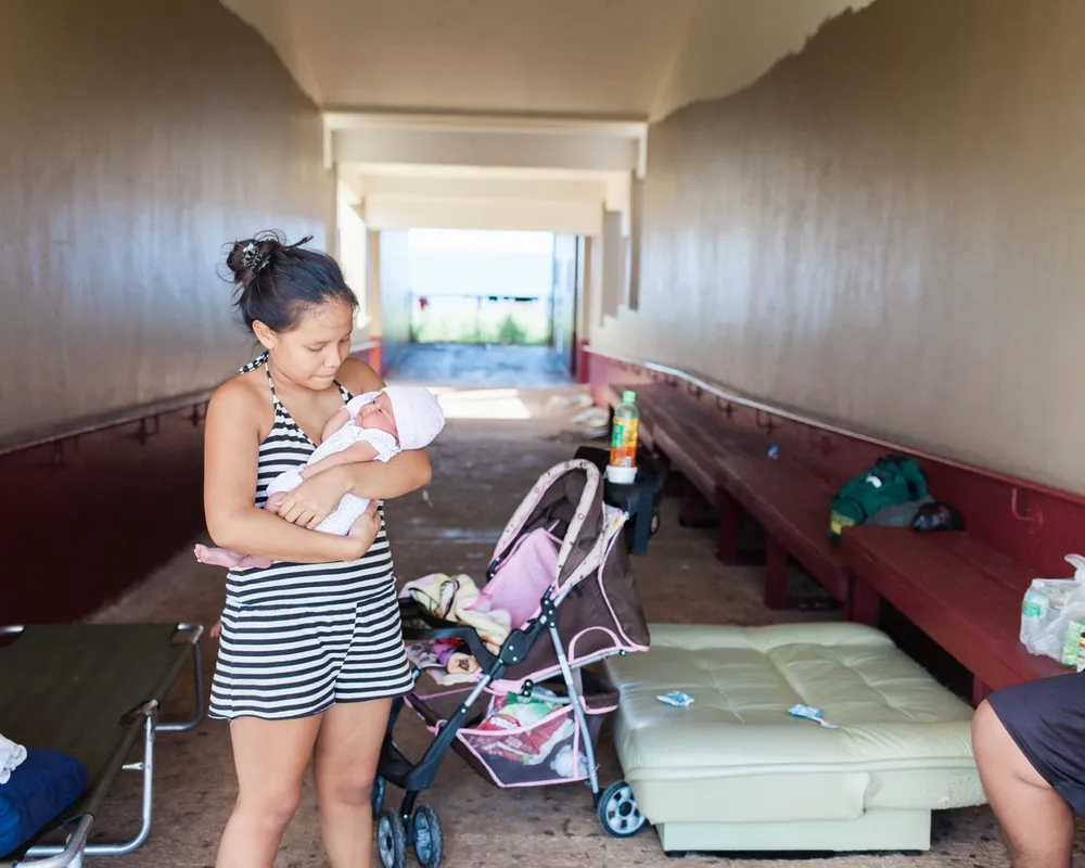 Baby and mother in shelter, Saipan