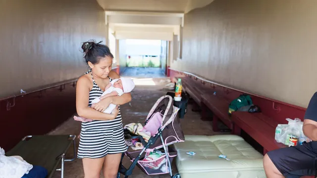 Baby and mother in shelter, Saipan