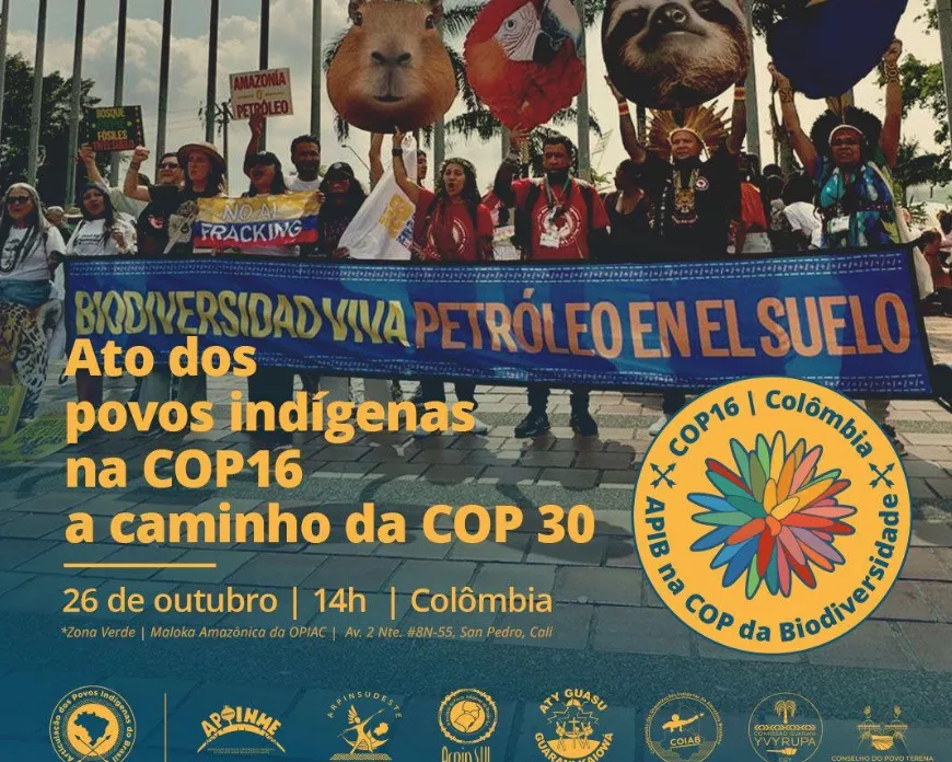 Protesters hold animal puppets and banner at climate demonstration. Banner reads "BIODIVERSIDAD Y VIDA PETROLEO EN EL SUELO" advocating for indigenous peoples at COP16 biodiversity conference in Colombia.