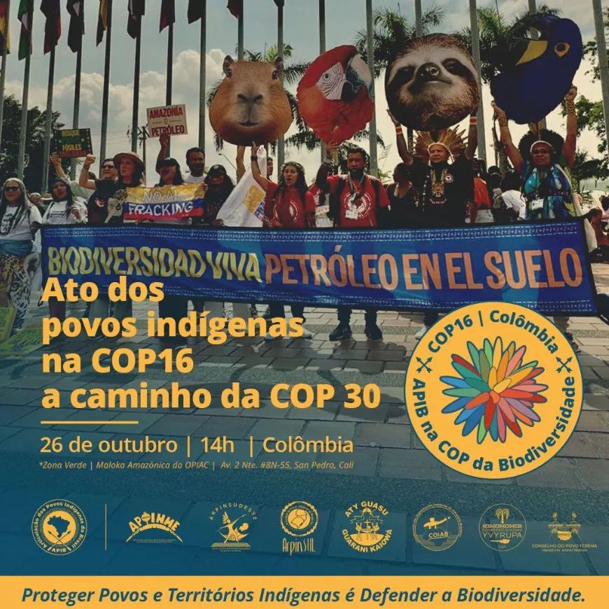 Protesters hold animal puppets and banner at climate demonstration. Banner reads "BIODIVERSIDAD Y VIDA PETROLEO EN EL SUELO" advocating for indigenous peoples at COP16 biodiversity conference in Colombia.