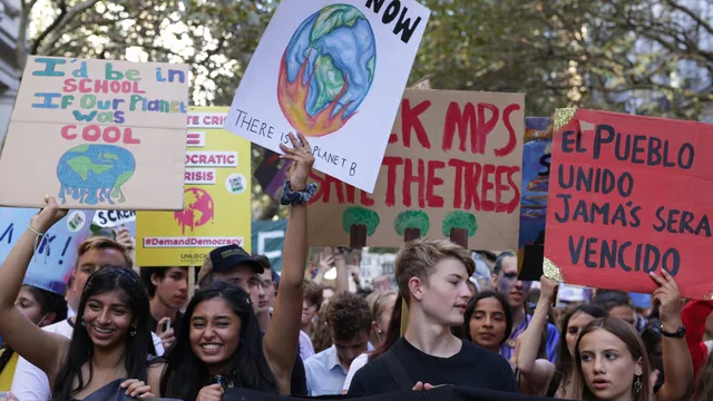 crowd of climate strike protesters holding banners