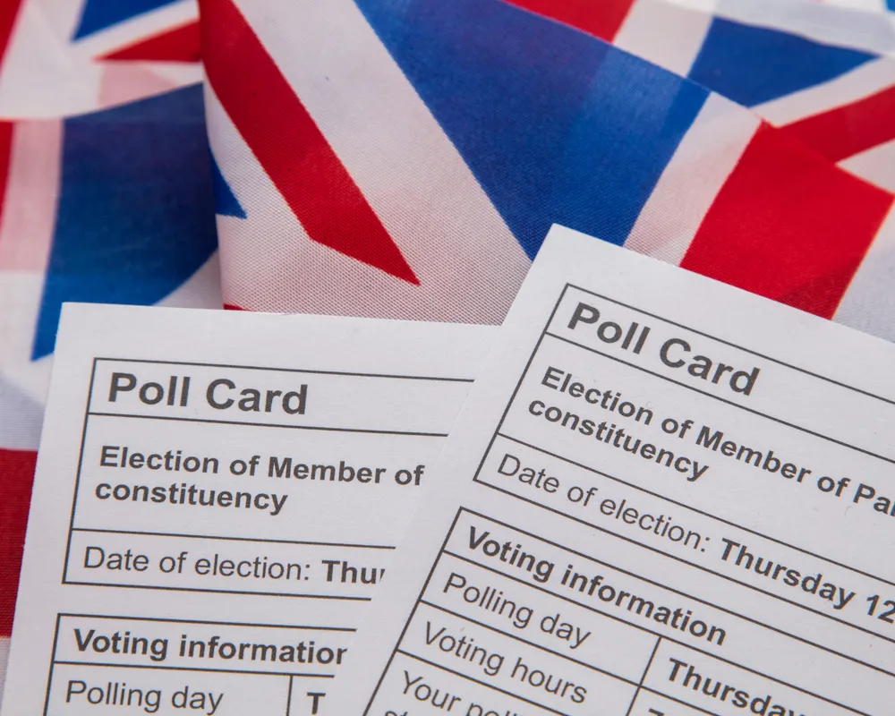 Election voting poll papers on top of UK flags