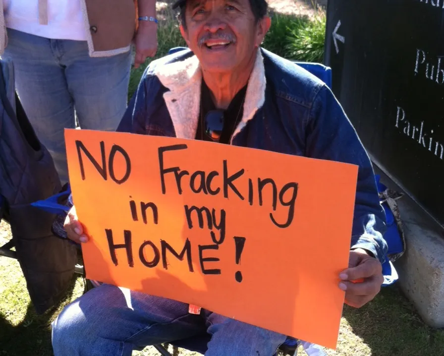“No fracking in my home” reads the bright orange sign held by Javier Cruz as he and his fellow community members fast outside the Kern County Board of Supervisors office in Bakersfield, California.