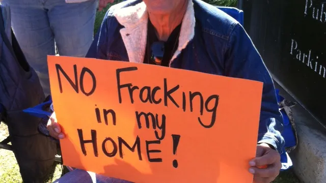 “No fracking in my home” reads the bright orange sign held by Javier Cruz as he and his fellow community members fast outside the Kern County Board of Supervisors office in Bakersfield, California.