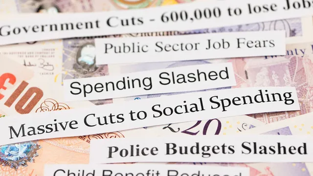 A background of money with ripped paper headlines on top. Headlines read spending slashed, massive cuts to social spending, child benefit reduced, etc.