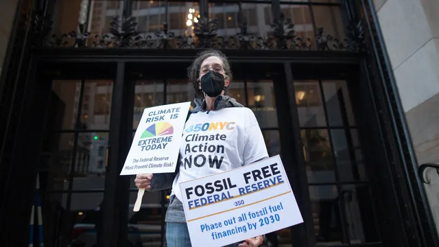 Climate activist outside of the Federal Reserve in NYC