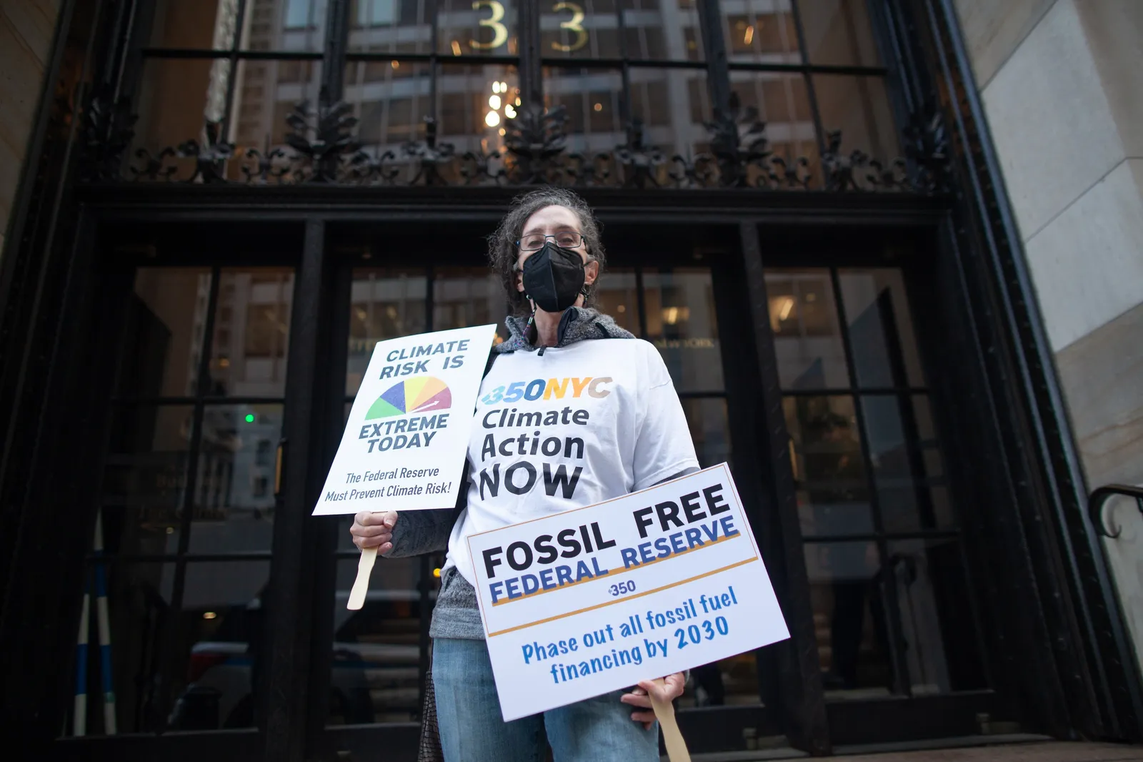 Climate activist outside of the Federal Reserve in NYC