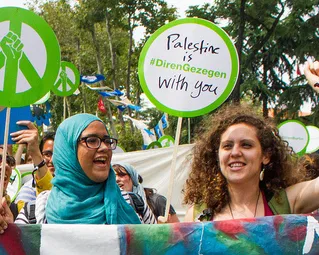 Muna holding her fist up in solidarity at the Global Power Shift march in Istanbul, June 30, 2013