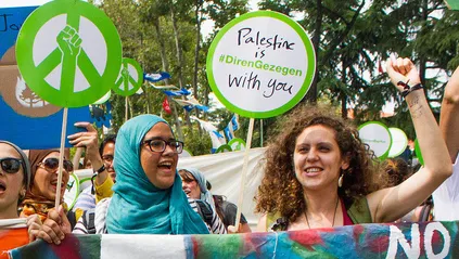 Muna holding her fist up in solidarity at the Global Power Shift march in Istanbul, June 30, 2013