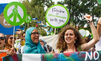 Muna holding her fist up in solidarity at the Global Power Shift march in Istanbul, June 30, 2013